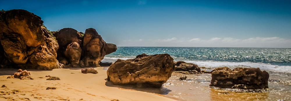 Boulders on a sunny beach